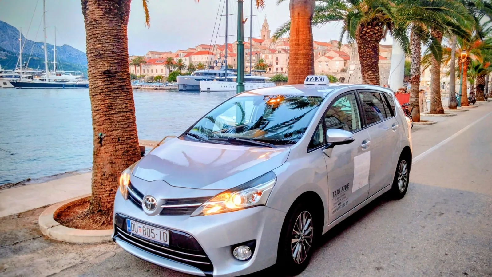 Korčula Island Taxi parked on the palm-lined riva in front of Korčula old town